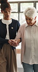 Caregiver, holding hands and walk with senior woman for support, balance or healthcare service. Assisted living, volunteer or helping elderly person with disability, arthritis and recovery in home