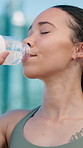 Runner, fitness and woman in city with water on break for exercise, workout and training. Sports, town and person with liquid for hydration, minerals and drink for wellness, recovery and health