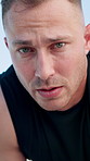 Runner, sweat and face of man for rest in city for exercise, cardio workout and training. Portrait, athlete and person with fatigue, tired and breathe for active hobby, wellness and fitness in town