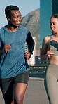 Active friends, training and running on bridge, fitness and cardio for marathon in city and together. Outdoor, athlete and people with smile on race, wellness and workout routine for sport tournament