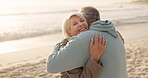 Outdoor, old couple and hug with smile at beach, romance and bonding with partner on summer holiday. Ocean, senior people and embrace on peaceful vacation, love and happy for retirement in nature