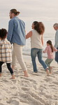 Beach, big family and holding hands on walk for holiday, bonding or talk with grandparents. Generations, children and parents by ocean for love, smile and back with interracial people on vacation