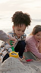 Playing, sand and grandmother with children by beach on holiday, getaway or weekend trip. Toys, bonding and senior woman with kids for connection, fun and development by ocean on vacation together.