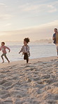 Running, travel and family by beach in summer on holiday, getaway or weekend trip together. Happy, playing and children with parents by ocean for fun, bonding or connection on seaside vacation.
