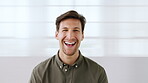 Business, face and funny with man on wall background in office for career development or humor. Laughing, professional and reaction with happy employee person in workplace for job satisfaction