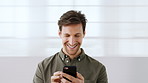Phone, happy and businessman by wall in office for email, networking or communication on mobile app. Laughing, technology and male employee with cellphone for online contact in workplace by space.