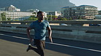Black man, running and fast on bridge for fitness in city for cardio, training and wellness in summer. African person, outdoor and sprint for speed development, workout and exercise in urban street