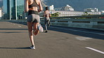 Running, training and women in city, back and exercise for health benefits, routine and challenge. Energy, friends and people in street, cardio workout and fitness for wellness, endurance or support