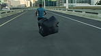 Back, running and black man in city, parachute and training for health benefits, challenge and workout. Fitness gear, person and runner in street, resistance and exercise for wellness goals or energy