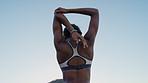 Woman, fitness and stretching for arms in city for circulation, space and back muscle in summer. Person, runner and sky with warm up exercise for wellness benefits, outdoor or start in urban town