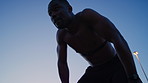 Black man, runner and tired with thinking in city for fitness with sweat, shirtless and space in evening. African person, outdoor and breathe with recovery, cardio or exercise with low angle in town