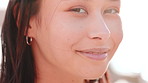 Wellness, windy or woman at ocean with face, positive attitude or chill on weekend break. Peace, sunshine or Asian person at seaside with fresh air, good mood or outdoor getaway in New Zealand.