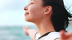 Happy, woman and breathing on beach with open arms, wind and reflection for inspiration on vacation. Female person, smile and mindfulness outdoor on holiday with ocean breeze, wellness and fresh air.