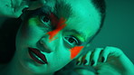 Neon, beauty and woman with makeup, face paint and aesthetic with transformation on background. Portrait, cosmetics and serious person with art in studio, creative color and change with lipstick