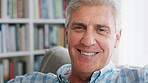 Face, smile and mature man in living room with peace, wellness and positive attitude on weekend break. Happy, male person and relax in home with calm afternoon, free time and good mood on couch.