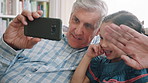 Grandpa, phone and video call with girl on sofa in home living room for bonding, laughing or visit. App, love and wave of senior with happy granddaughter in apartment for virtual communication