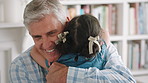 Grandfather, child and hug for reunion in home, love and bonding together with family greeting. Kid, happy girl and embrace grandparent for welcome with hello, connection and support for care