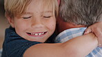 Happy, boy and grandfather in living room with hug, bonding together and support for development. Senior man, grandchild smile and embrace in home with connection, love and trust on weekend break.
