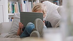 Couch, relax and child with tablet for gaming, digital world and internet website for online activity. Chill, entertainment platform and boy with tech for virtual contest, engagement and play in home