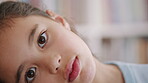 Curious, education and face with girl in classroom for child development, learning or study. Academics, future and knowledge with student kid in class of school for curriculum, growth or syllabus