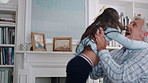 Happy, old man and child jumping in home with energy, playful fun and bonding together. Smile, grandfather or catching kid with support, visit grandparent and babysitting grandchild for weekend break