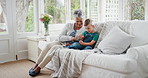 Grandma, phone and pointing with boy child on sofa in home living room for bonding, love or visit. App, gaming or scrolling with grandson and happy senior woman in apartment together for streaming