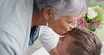 Grandmother, child and kiss on forehead for love in home, trust and together with foster family. Kid, boy and connection with grandparent, generations or smile for adoption with interracial people