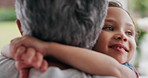 Smile, grandparent or girl in house with hug, childcare or bonding together in healthy relationship. Love, old woman or grandchild with embrace, support or family connection for childhood development