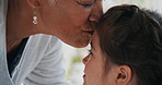 Grandma, child and kiss for care in house, trust and connection together with foster family. Kid, girl and affection with grandmother for love, smile or support for adoption with interracial people
