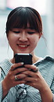 Typing, walking and Asian woman with phone in city for communication, urban commute and travel on weekend. Outdoor, networking and person on smartphone for connection, social media and chat in Japan