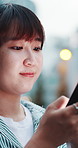 Happy, typing and Asian woman with phone in city for location, urban commute and travel on weekend. Outdoor, bokeh and person on smartphone for connection, social media and direction in Japan