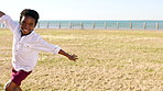 Airplane, kid and running in nature with arms for play, vacation and energy on summer break by ocean. African child, game and fly outdoor for freedom, adventure and happiness on holiday by sea