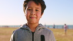 Travel, face or child in park with laugh, childhood holiday and fresh air on weekend break. Space, portrait or boy on field with happiness, youth vacation and outdoor getaway in New Zealand.