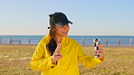 Teenager, girl and selfie by beach with peace sign, check phone and social media for summer holiday. Happy, gen z person and photography by ocean with tech, v gesture and online post for vacation.