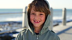 Face, promenade and kid with vacation, boy and beach for getaway trip, travel and tourism. Ocean, funny and child development for growth, summer holiday and weekend break with sunshine and nature