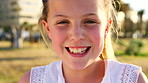 Happy, grass and portrait of child in nature on vacation, getaway or weekend trip in summer. Smile, confident and girl kid in park for holiday with growth, development or positive attitude in London.