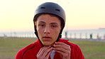 Face, teenager and boy in park, helmet and summer holiday to relax, travel weekend and safety. Outdoor, youth and child with break, sunshine or protection with vacation, adventure or getaway trip