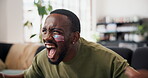 Victory, shout and black man in home with soccer game, goal excitement or celebration in sports tournament. Scream, watching or football fan with fist pump, score lead or winning cheer in Los Angeles