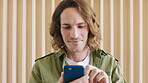 Reading, laugh and man with phone in creative agency, review project deadline and digital work newsletter. Check calendar, scroll email and person typing message for staff bulletin, smile and mobile