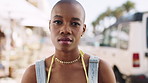 Face, city and black woman on vacation, travel and morning commute for holiday with trip. Portrait, bald person and serious tourist in urban town for adventure, summer and wanderlust in Kenya