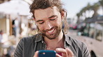 Happy man, phone and texting with typing in city for travel, meme or chat for online dating. Person, smartphone and scroll on mobile app, contact and smile with social media for tourism in urban town