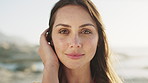 Happy, beach and face of woman on holiday for adventure, tourism and summer vacation outdoor. Weekend, travel and portrait of person by ocean, sea and nature for fresh air, relax and calm at sunset