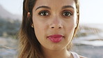 Travel, beach and face of woman on holiday for adventure, tourism and summer vacation outdoor. Weekend, calm and portrait of person by ocean, sea and nature for fresh air, relax and explore in Brazil