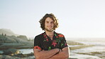 Travel, face and man with arms crossed at beach, space and chilling on vacation in nature or getaway. Ocean, traveler and happy person on holiday, adventure and tourism on weekend in San Francisco