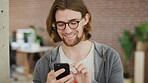 Design, phone and smile of man in office for career ambition, development or intelligence. Business, scrolling and social media with happy designer in creative workplace for agency employment