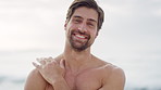 Outdoor, face and man with smile at beach, travel and laughing on summer vacation in nature or break. Ocean, traveler and happy person on holiday, adventure and humor on weekend in San Francisco