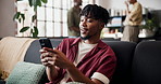 Happy, typing and man in home, smartphone for social media and digital app for communication. Smile, laughing and person on sofa, funny meme and cellphone for online humor and message to contact