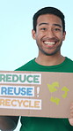 Face, volunteer and man with poster in studio, happy and social responsibility with recycle message. Blue background, ngo and person with smile for eco friendly info, news and sign for announcement