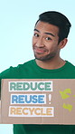 Poster, volunteer and face of man in studio for awareness on global warming, climate change or sustainability. Charity, portrait and person with sign for recycle, waste or activism on blue background