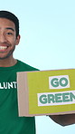 Banner, volunteer and face of man in studio for awareness on global warming, climate change or sustainability. Charity, portrait and person with sign for recycle, waste or activism on blue background